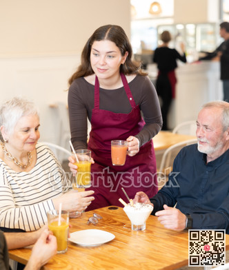 Female waitress delivering juice to customers