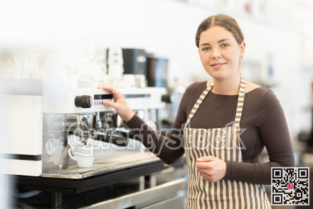 Woman barista making coffee