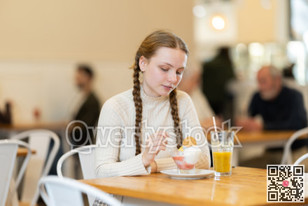 Teenage girl sitting in cafe with dessert
