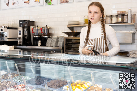 Teenage girl offering delicious ice cream in a coffee shop