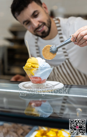 Guy chef or vendor serves ice cream