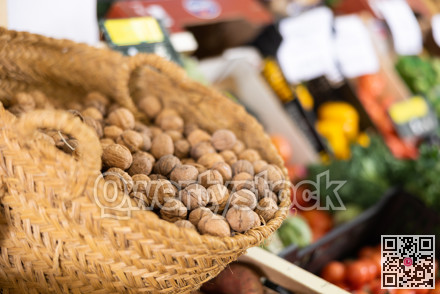 Walnuts in basket on shelf in greengrocery