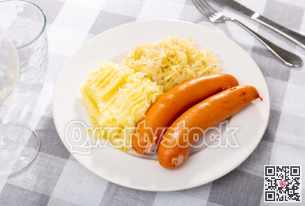 Sausages served with potatoes and cabbage