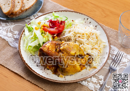 Tender meat of roasted chicken is garnished with boiled rice, vegetable salad.