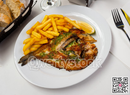 Grilled gilthead bream fish served with potatoes