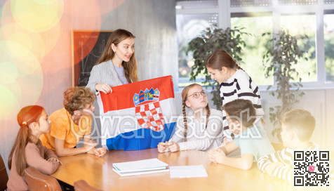 Teacher showing Croatia flag to group of schoolchildren