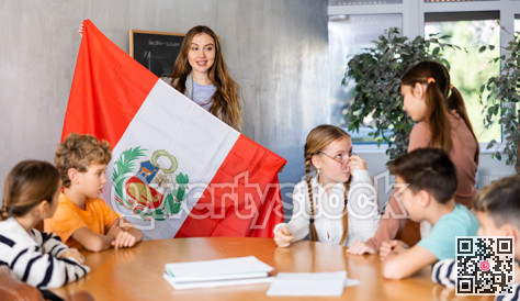 Teacher showing Peru flag to group of schoolchildren