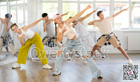 Teenage girl dancing hip hop in group