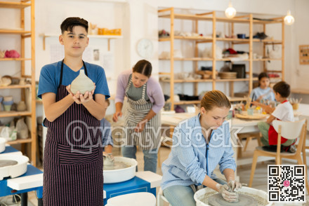 Teenage boy standing with handmade jug in hand