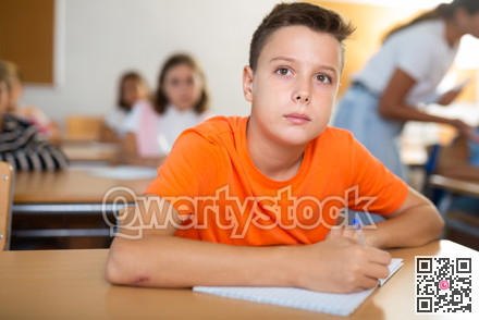 Young boy learning in school