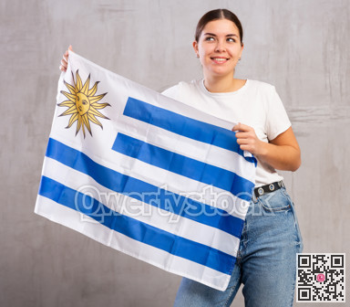 Happy girl with Uruguay flag in her hands