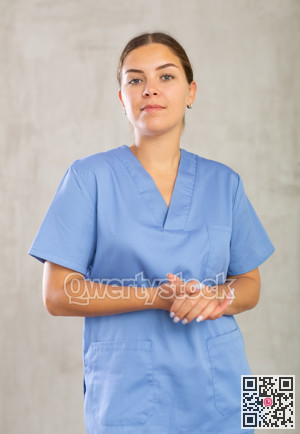 Young woman posing in medical uniform in studio