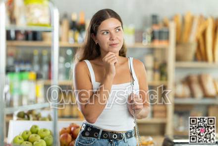 Young woman choosing groceries in store