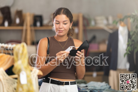 Girl customer choose high heels shoes in store
