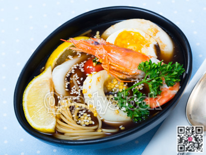 Spicy pan-Asian soup with squid, shrimp, egg noodles and sesame is tasty dish