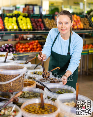 woman seller offers to buy olives