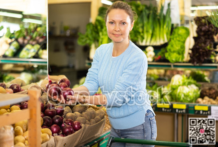 woman buy large onion in supermarket