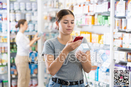 In pharmacy visitor scan QR Code and reads composition of cream for problematic skin.