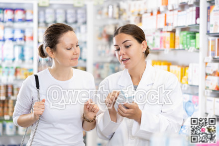 Woman pharmacist helping woman customer to choose remedy in pharmacy