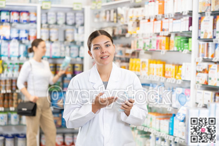 In pharmacy, apothecary holds package with cream for sensitive skin and talks about nuances of care