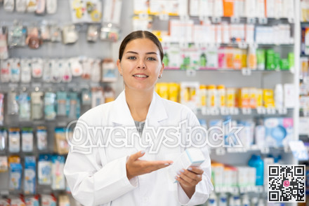 In pharmacy, apothecary holds package with cream for sensitive skin and talks about nuances of care