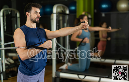 man doing arm strength exercises on reformer