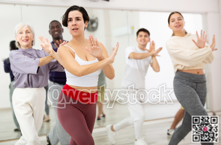 Happy Latina enjoying active dancing during group training