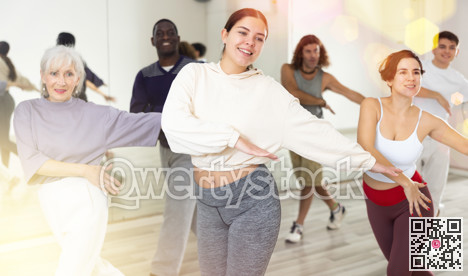 Cheerful girl enjoying active dancing during group training