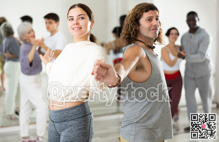 Confident couple of dancers enjoys a partner dance