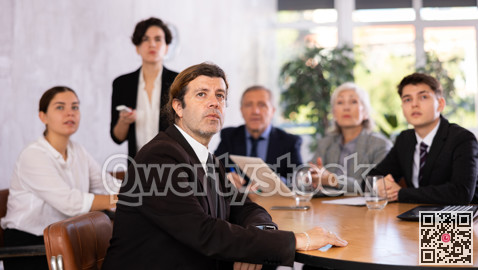 Group of business people attending meeting in conference room, discussing work plan