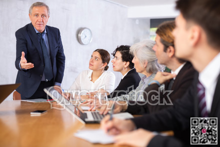 Successful businessman tells his colleagues the presentation and future plans of company