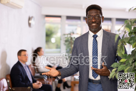 Happy middle-aged man standing with his back to waiting room