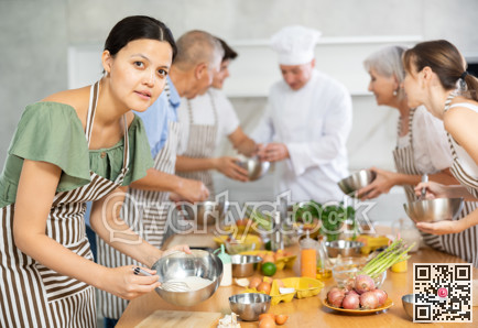 Cooking course - male chef in cook uniform teaches young people cooking class students to prepare and mix ingredients for dishes in restaurant kitchen
