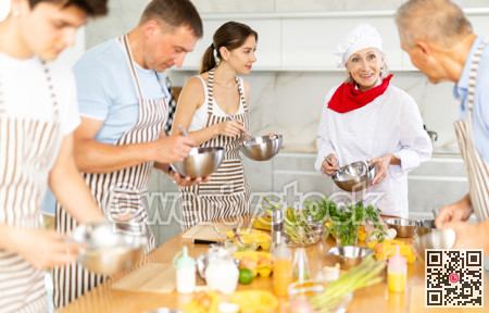 Amiable senior female chef running group culinary courses