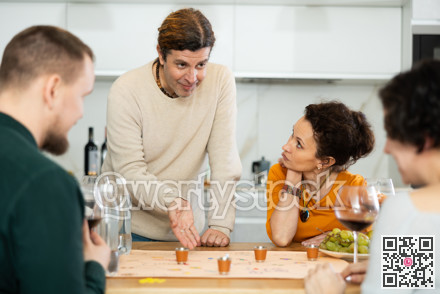 Group of friends is playing board game.