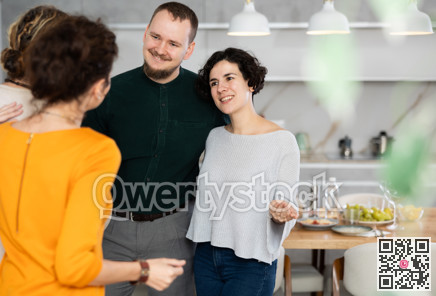 Husband and wife stand side by side and say goodbye to guests