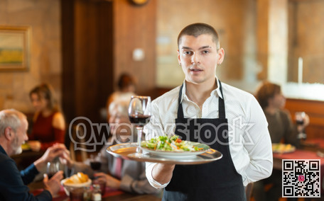 Guy waiter with tray in cafe hall