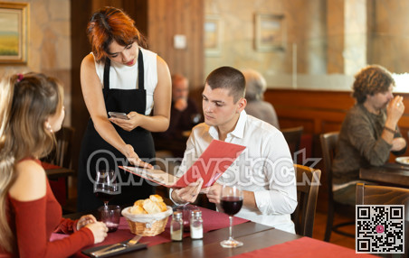 Waitress takes order from couple young man and woman