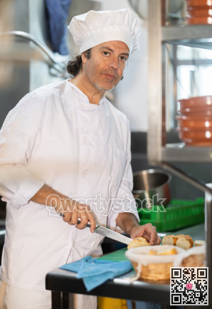 Man cook in kitchen finely slices food