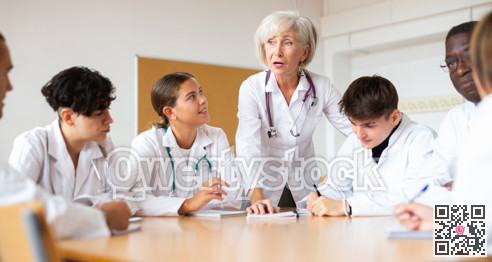 Professor explaining subject to group of medical students