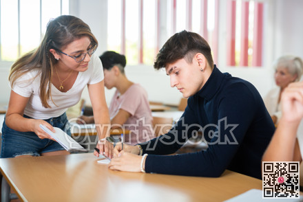 Female teacher prompts an adult student to solve equation