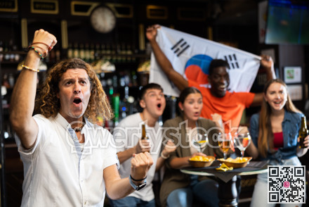 Excited man rooting for favorite team of South Korea in sports bar
