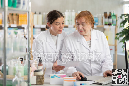 Two pharmacists working at a computer in a pharmacy