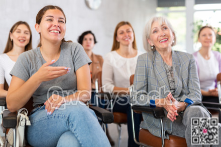Young positive woman listening to lecture in office