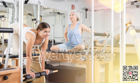 Young girl doing exercises on wunda chair in pilates studio