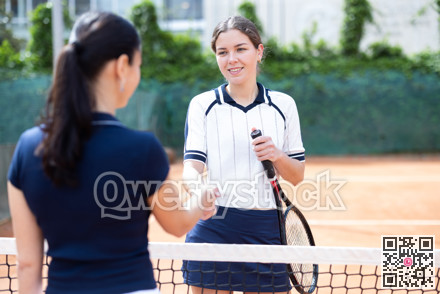 Young woman tennis player shaking hands with her opponent