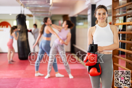Woman with boxing gloves learning punches