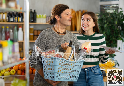 Married couple searches for fresh produce in the grocery section of supermarket