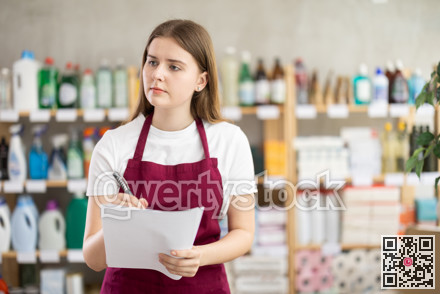 Young woman seller conducting inventory in store
