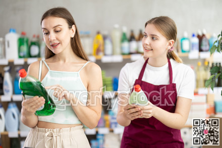 Sales girl offers woman choose dishwashing in household supermarket